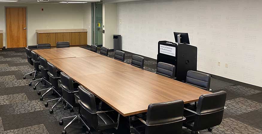 Small Board Room with long table and chairs along each side