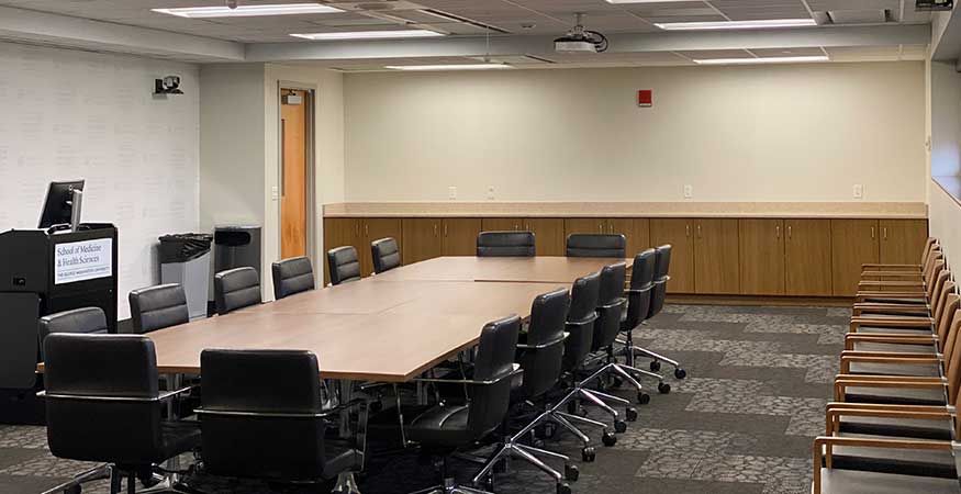Small Board Room with long table and chairs along each side